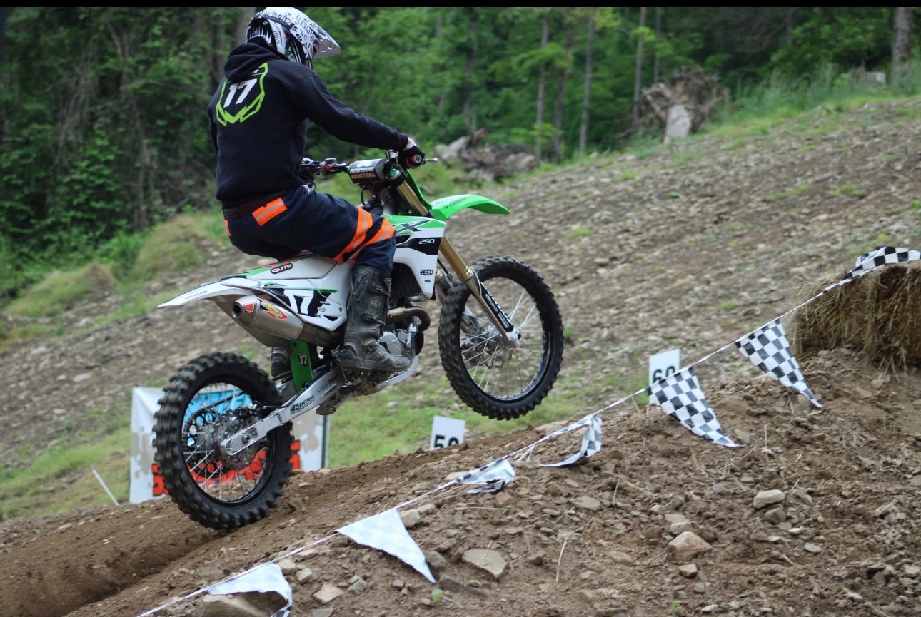 Dirt bike racer powering uphill